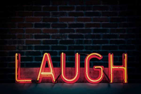 lighted sign that says "laugh"