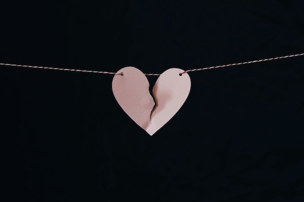 broken paper heart hanging on a wire
